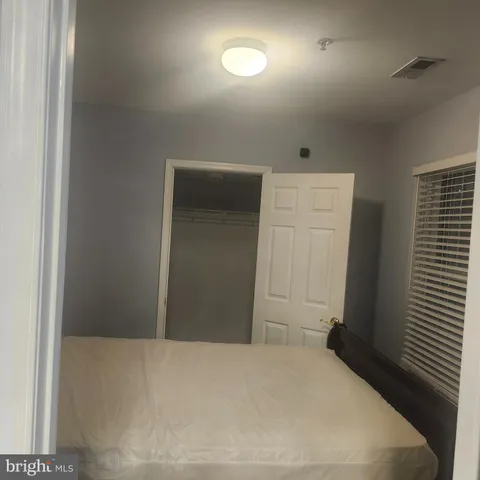 a bedroom with a bed and a mirror