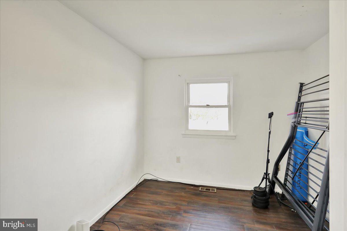 1118 Fox Run Reading, PA 19606 - Photo 15 of 19 a view of an empty room with wooden floor and a window