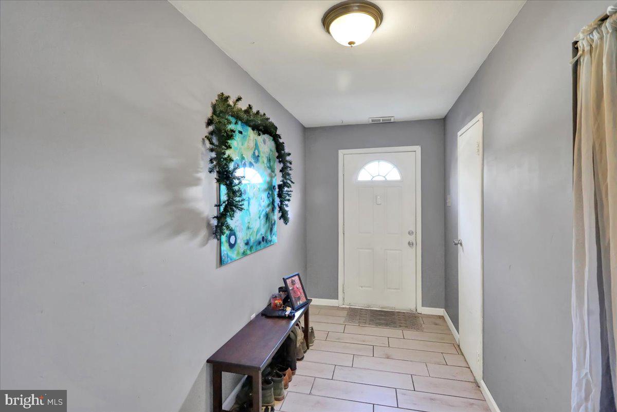 1118 Fox Run Reading, PA 19606 - Photo 9 of 19 wooden floor in a hall with a window