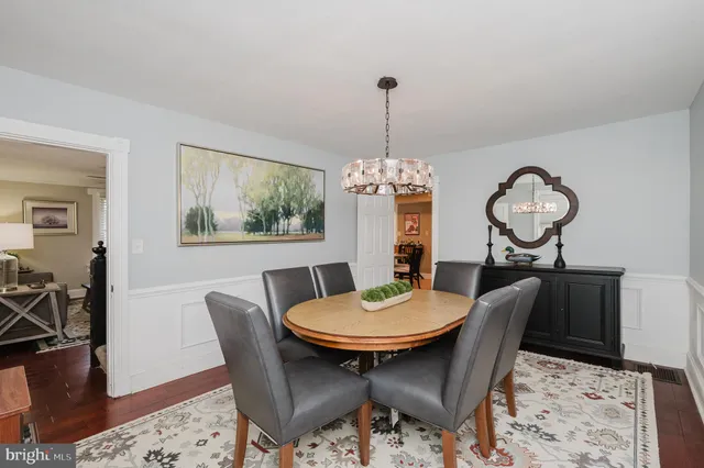 a kitchen with stainless steel appliances granite countertop a sink a stove a microwave and wooden cabinets