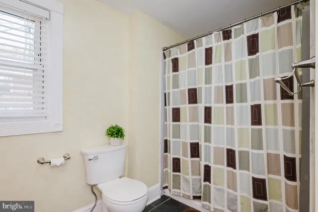 a bathroom with a granite countertop sink a mirror and a shower