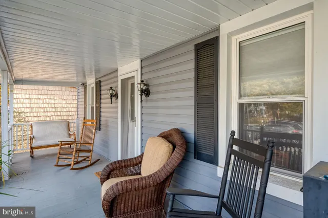 a living room with furniture a rug and a window