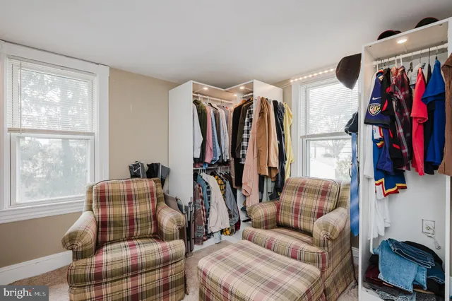 a view of a house with a backyard and sitting area