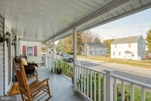 a dining room with furniture a rug and wooden floor