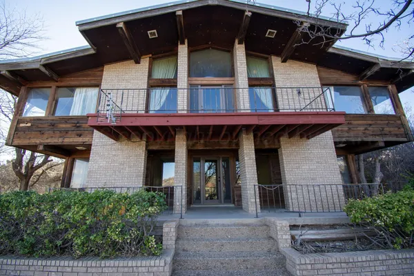 a view of a hallway with wooden shelves and a couch