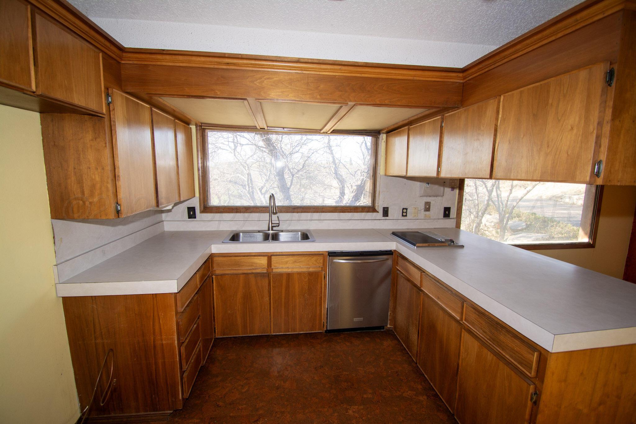 4 Windsor Road Amarillo, TX 79124 - Photo 11 of 41 a kitchen with a sink a window and cabinets