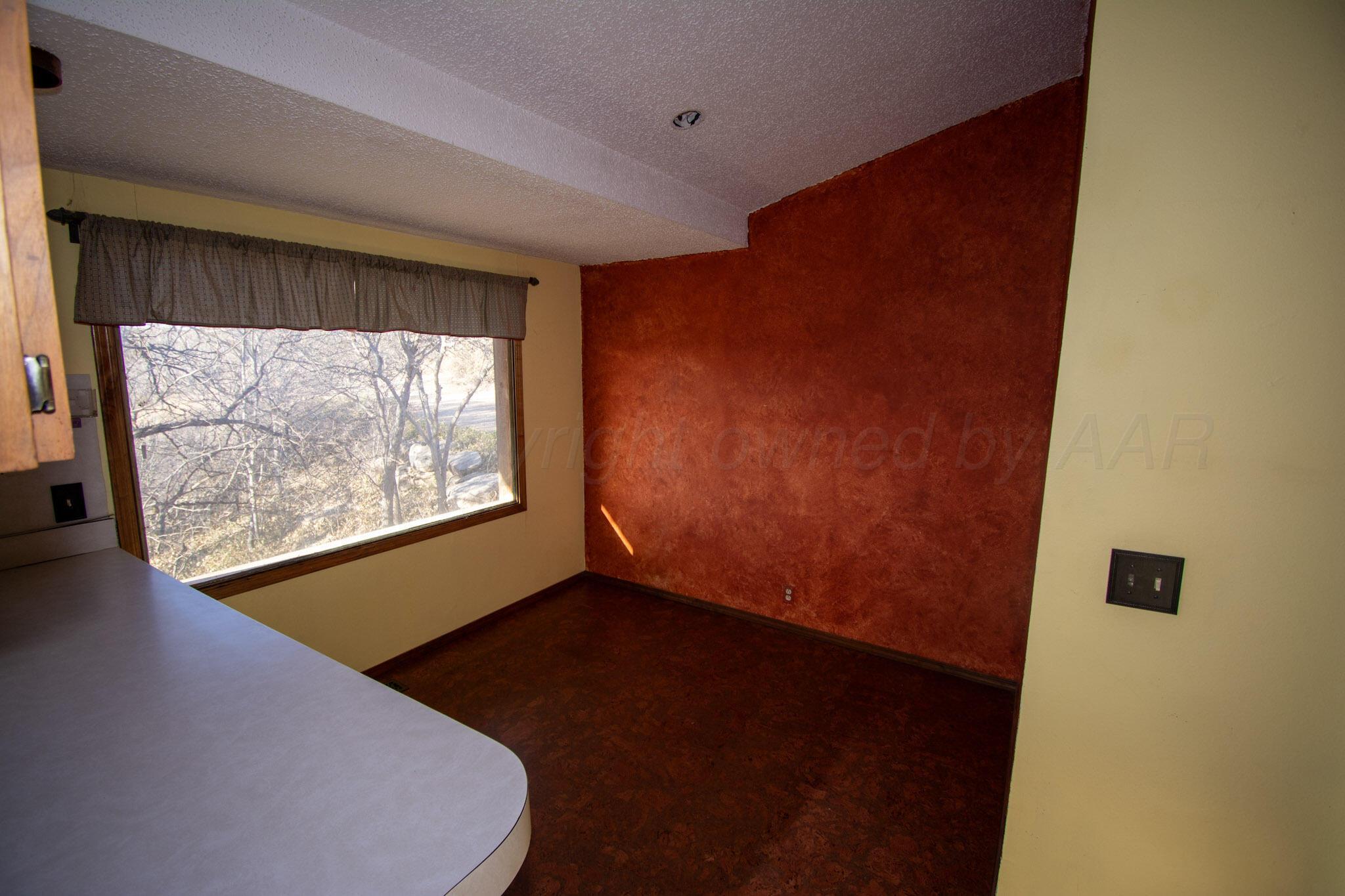 4 Windsor Road Amarillo, TX 79124 - Photo 12 of 41 a view of an empty room with wooden floor and a window