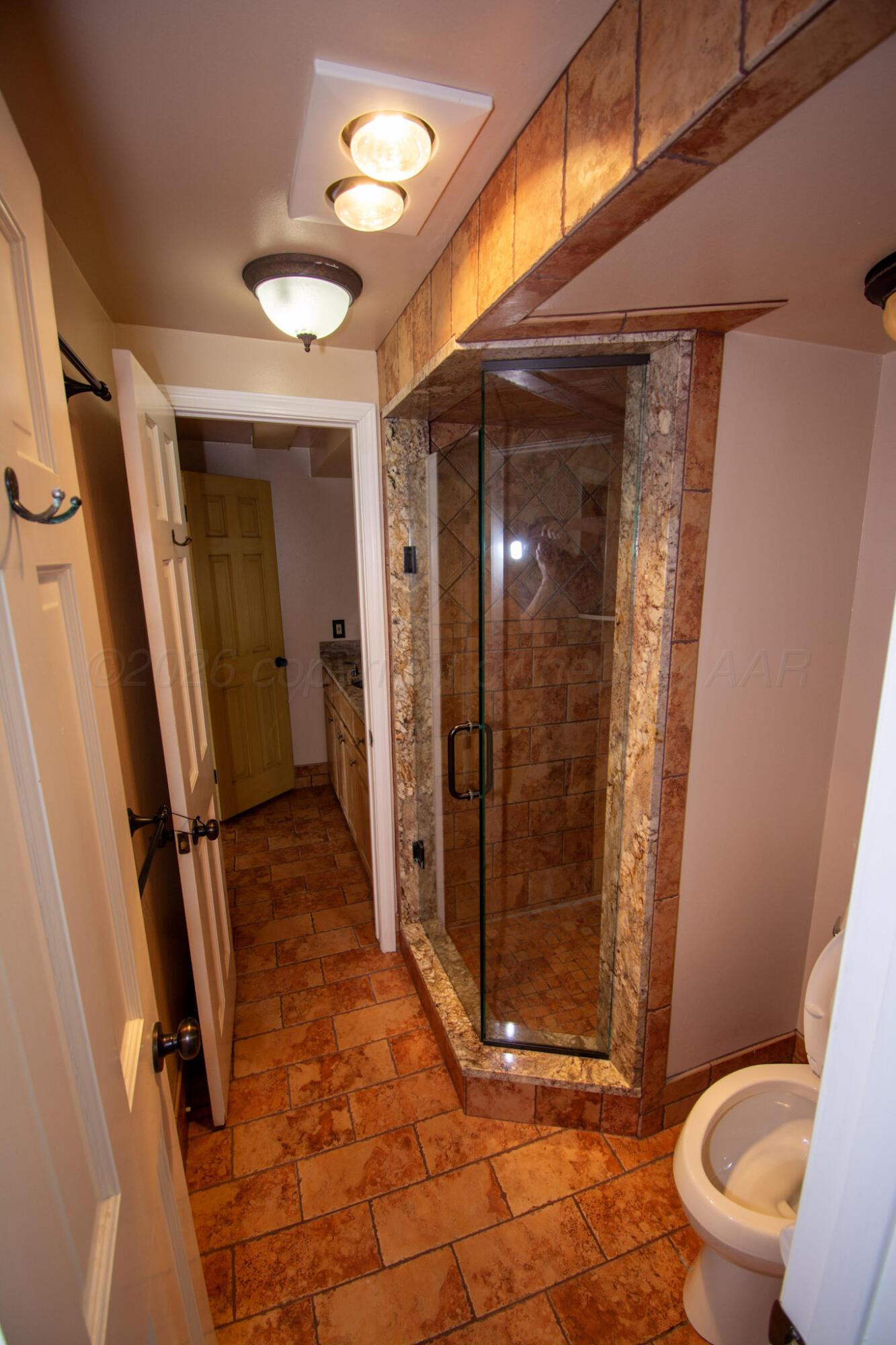 4 Windsor Road Amarillo, TX 79124 - Photo 22 of 41 a bathroom with a shower and toilet