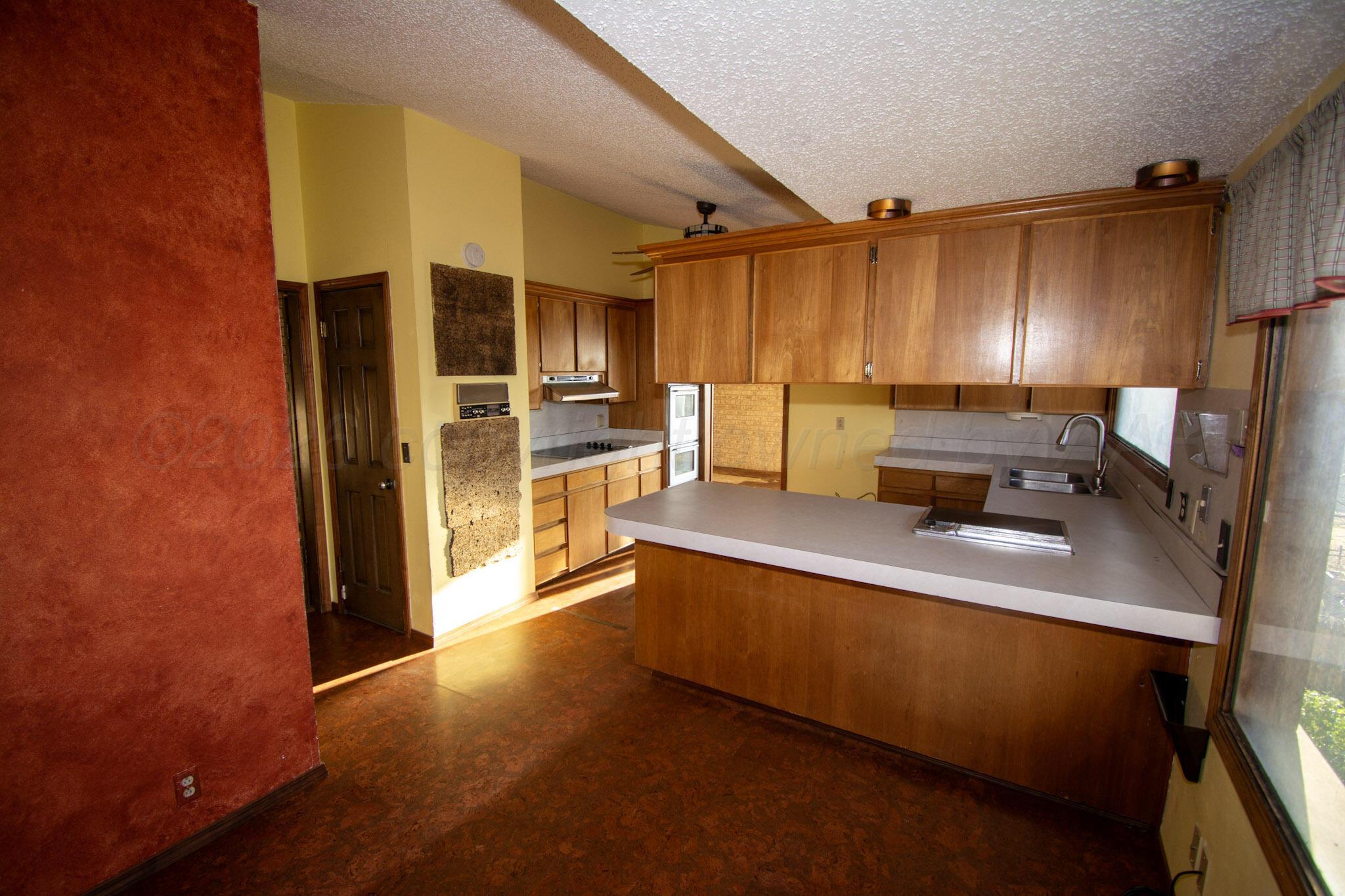 4 Windsor Road Amarillo, TX 79124 - Photo 8 of 41 a kitchen with stainless steel appliances a sink a stove and a refrigerator