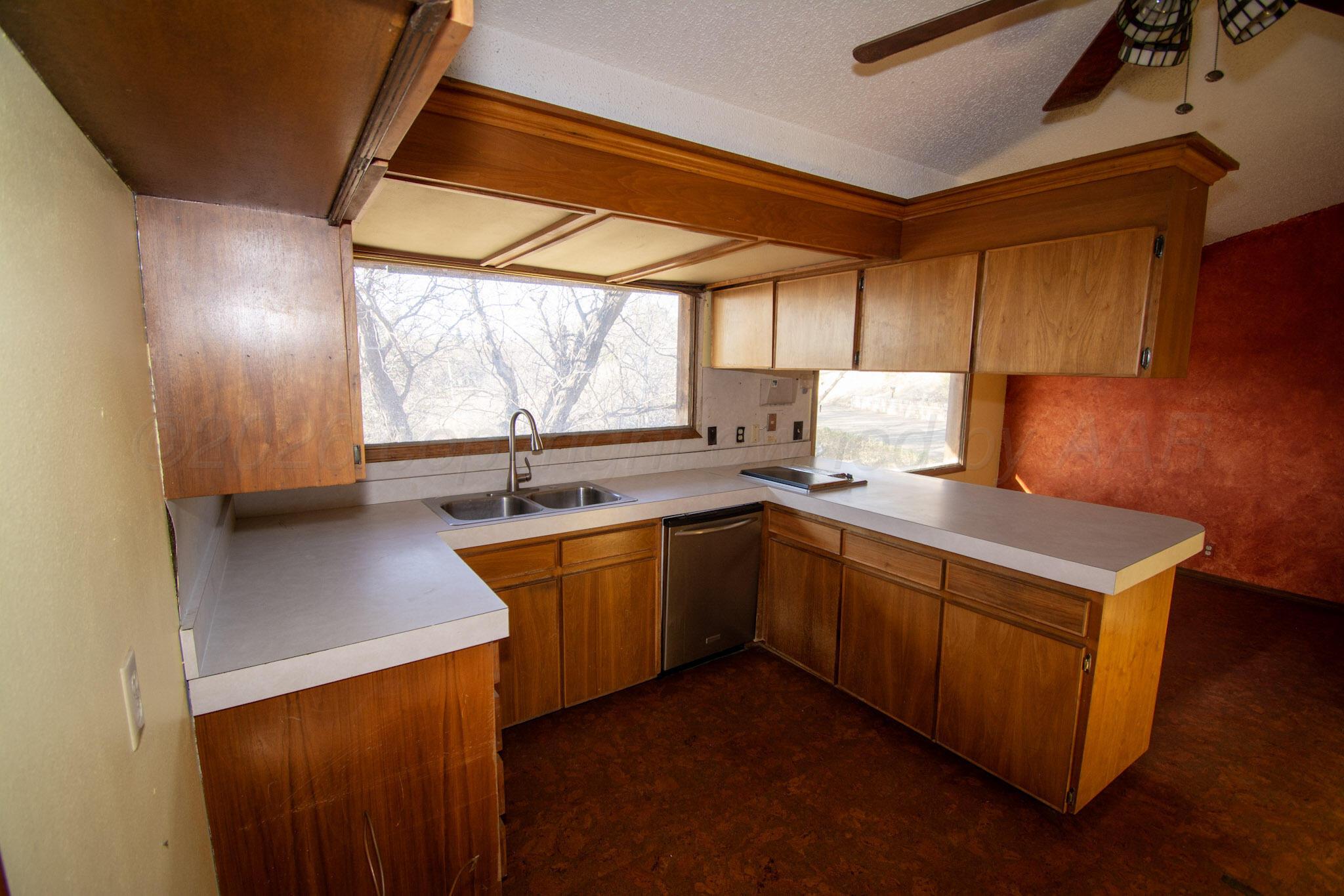 4 Windsor Road Amarillo, TX 79124 - Photo 10 of 41 a kitchen with stainless steel appliances a sink cabinets and wooden floor