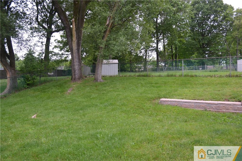 2 Dayton Road Edison, NJ 08817 - Photo 11 of 15 a backyard of a house with lots of green space and fountain