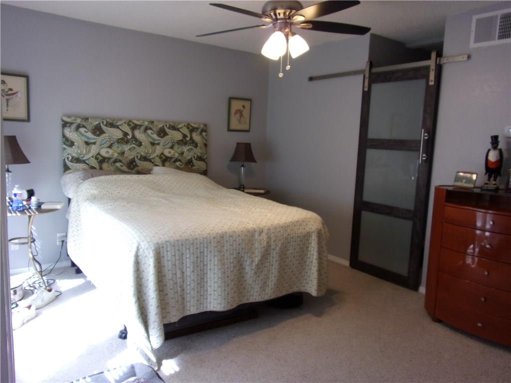 18240 Midway Road, Unit 105 Dallas, TX 75287 - Photo 12 of 37 Master Bedroom with Barn Door to Master Bath