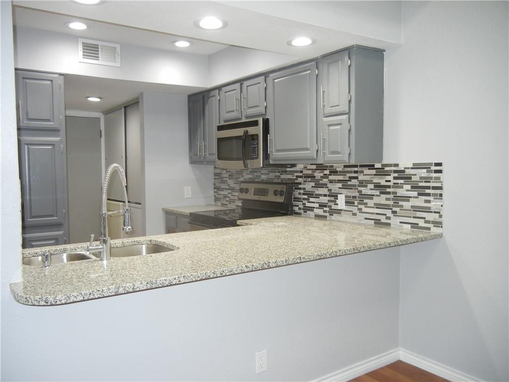 18240 Midway Road, Unit 105 Dallas, TX 75287 - Photo 1 of 37 Open Kitchen with Breakfast Bar