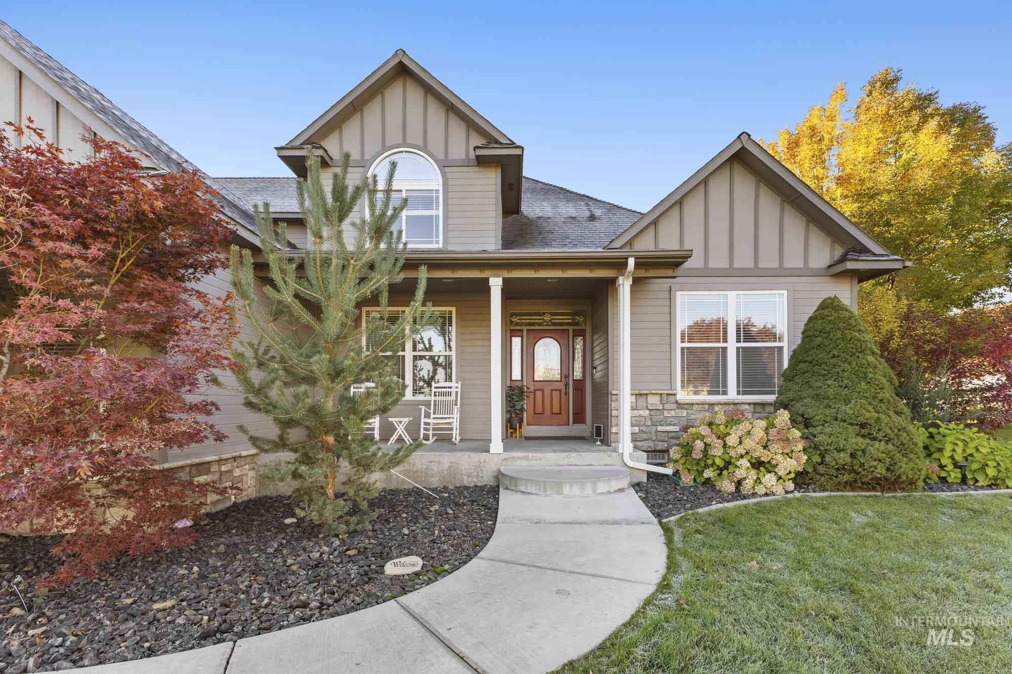 14820 Worden Way Caldwell, ID 83607 - Photo 1 of 44 View of front of home featuring board and batten siding, stone siding, a shingled roof, covered porch, and a front yard