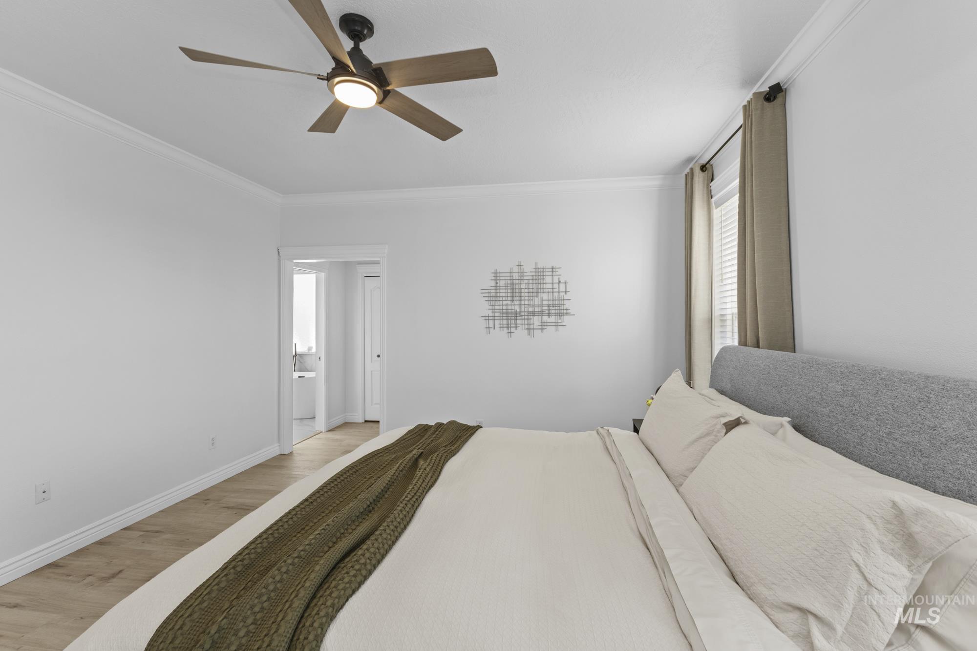 14820 Worden Way Caldwell, ID 83607 - Photo 24 of 44 Bedroom with light wood finished floors, crown molding, and ceiling fan
