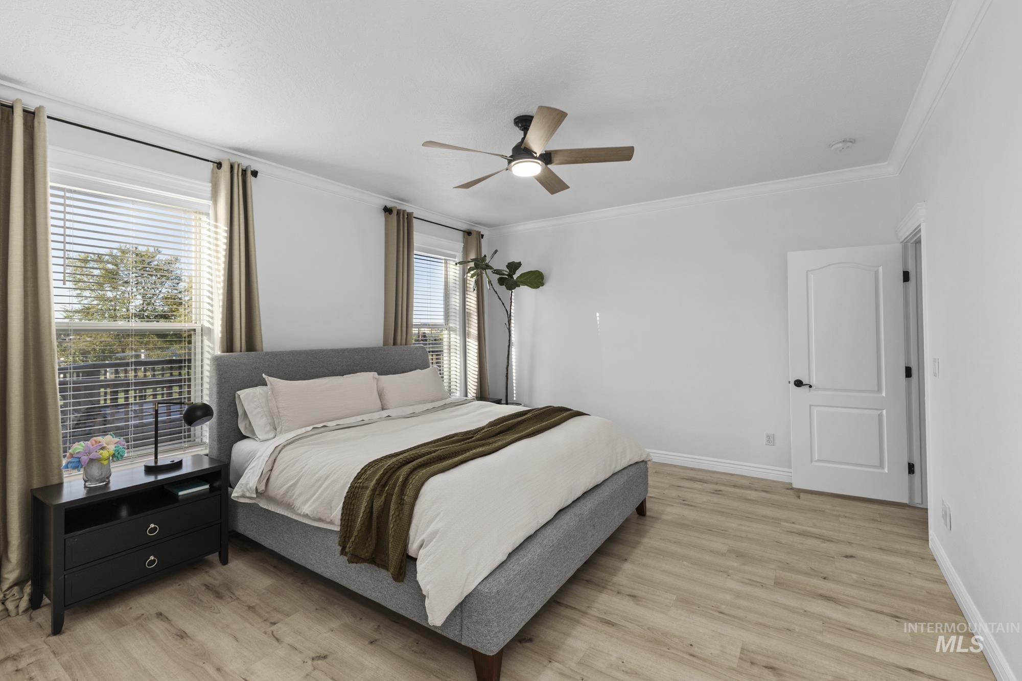 14820 Worden Way Caldwell, ID 83607 - Photo 25 of 44 Bedroom with light wood-style flooring, a ceiling fan, and crown molding