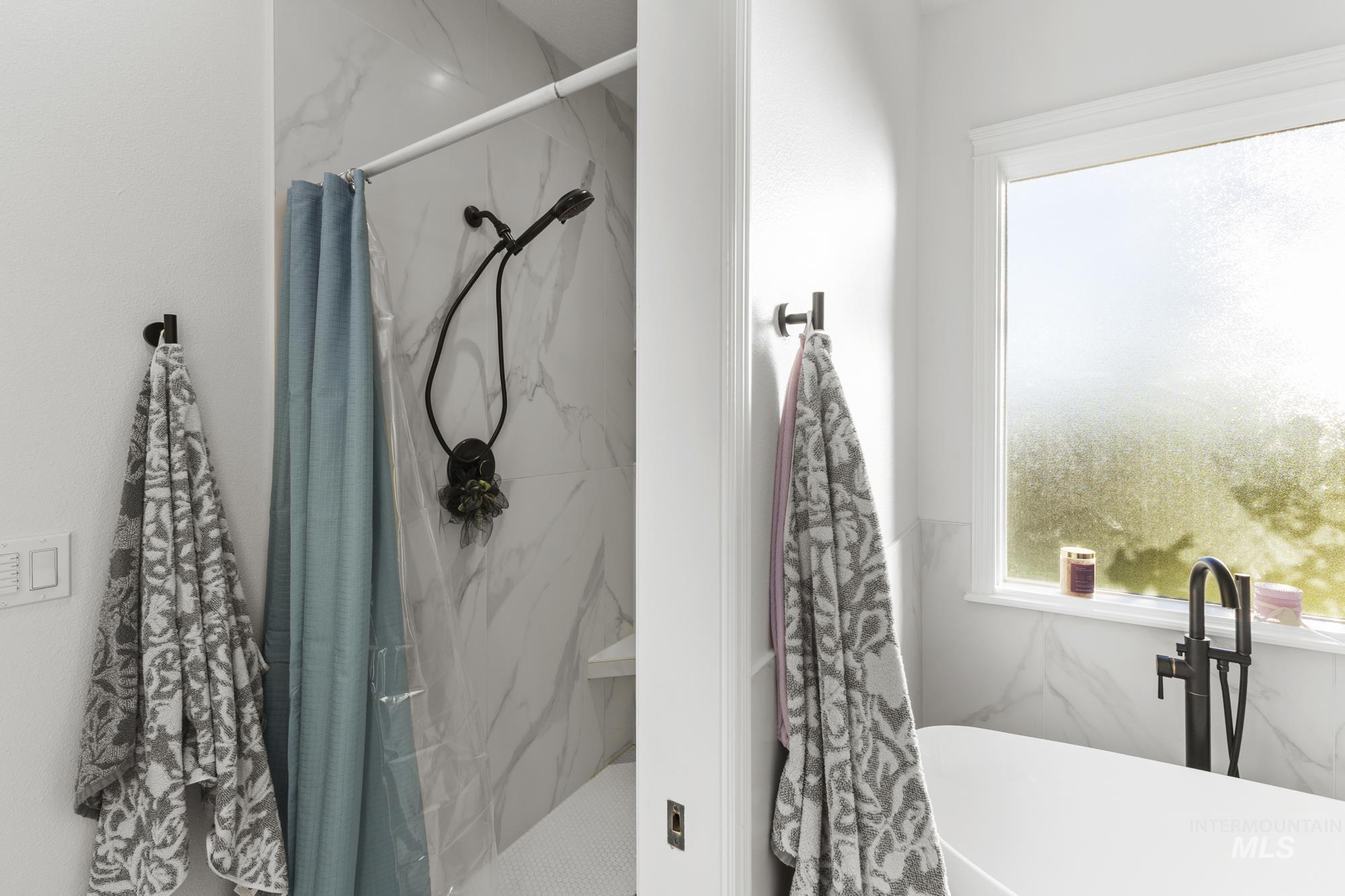 14820 Worden Way Caldwell, ID 83607 - Photo 29 of 44 Full bath with a freestanding tub and a marble finish shower