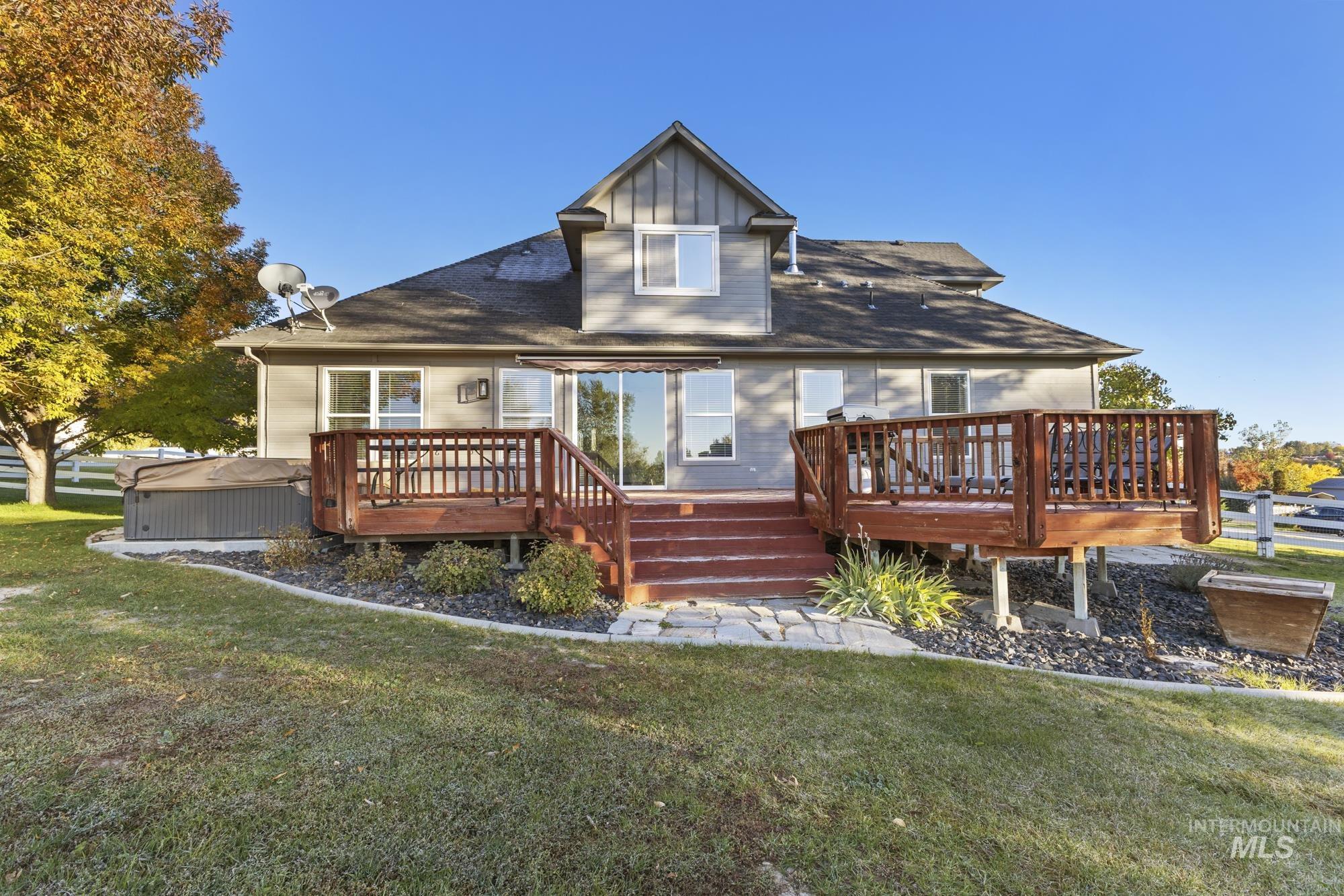 14820 Worden Way Caldwell, ID 83607 - Photo 43 of 44 Rear view of house with a wooden deck, a yard, and roof with shingles