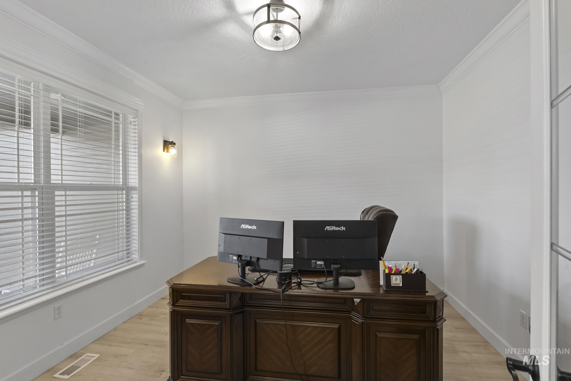 14820 Worden Way Caldwell, ID 83607 - Photo 8 of 44 Office area with light wood-style flooring and crown molding