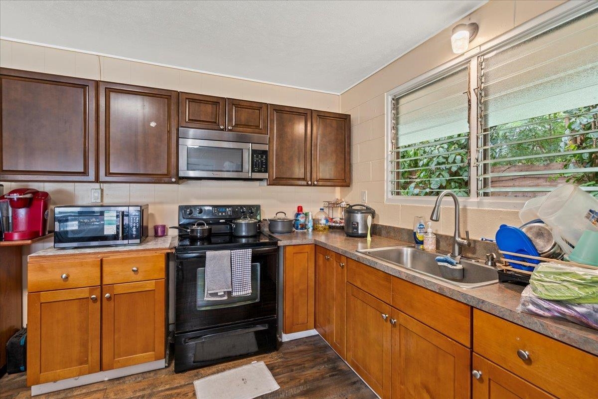 110 Aoloa Loop Kahului, HI 96732 - Photo 12 of 46 a kitchen with stainless steel appliances granite countertop a sink stove and cabinets