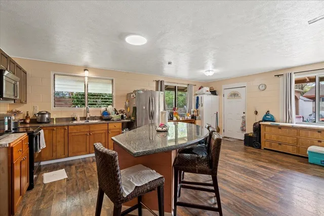 a dining room with furniture and wooden floor