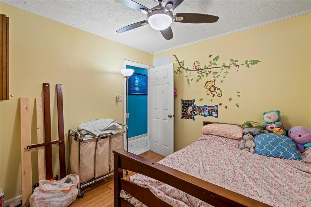 110 Aoloa Loop Kahului, HI 96732 - Photo 18 of 46 a bedroom with a bed and a chandelier