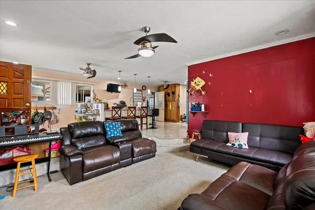 a living room with furniture a air conditioner and a fireplace