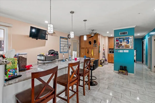 a view of a dining room with furniture and a flat screen tv