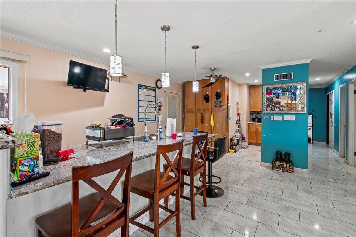 110 Aoloa Loop Kahului, HI 96732 - Photo 31 of 46 a view of a dining room with furniture and a flat screen tv