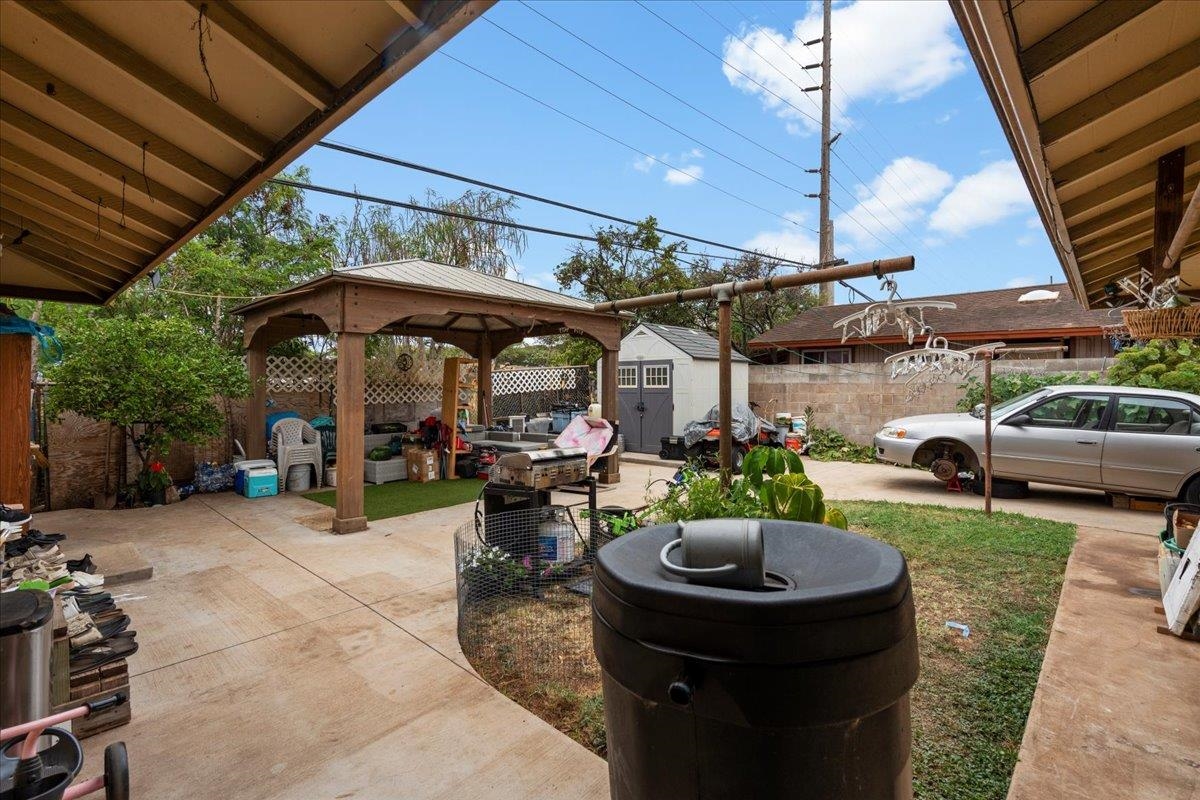 110 Aoloa Loop Kahului, HI 96732 - Photo 37 of 46 a view of a backyard with table and chairs under an umbrella