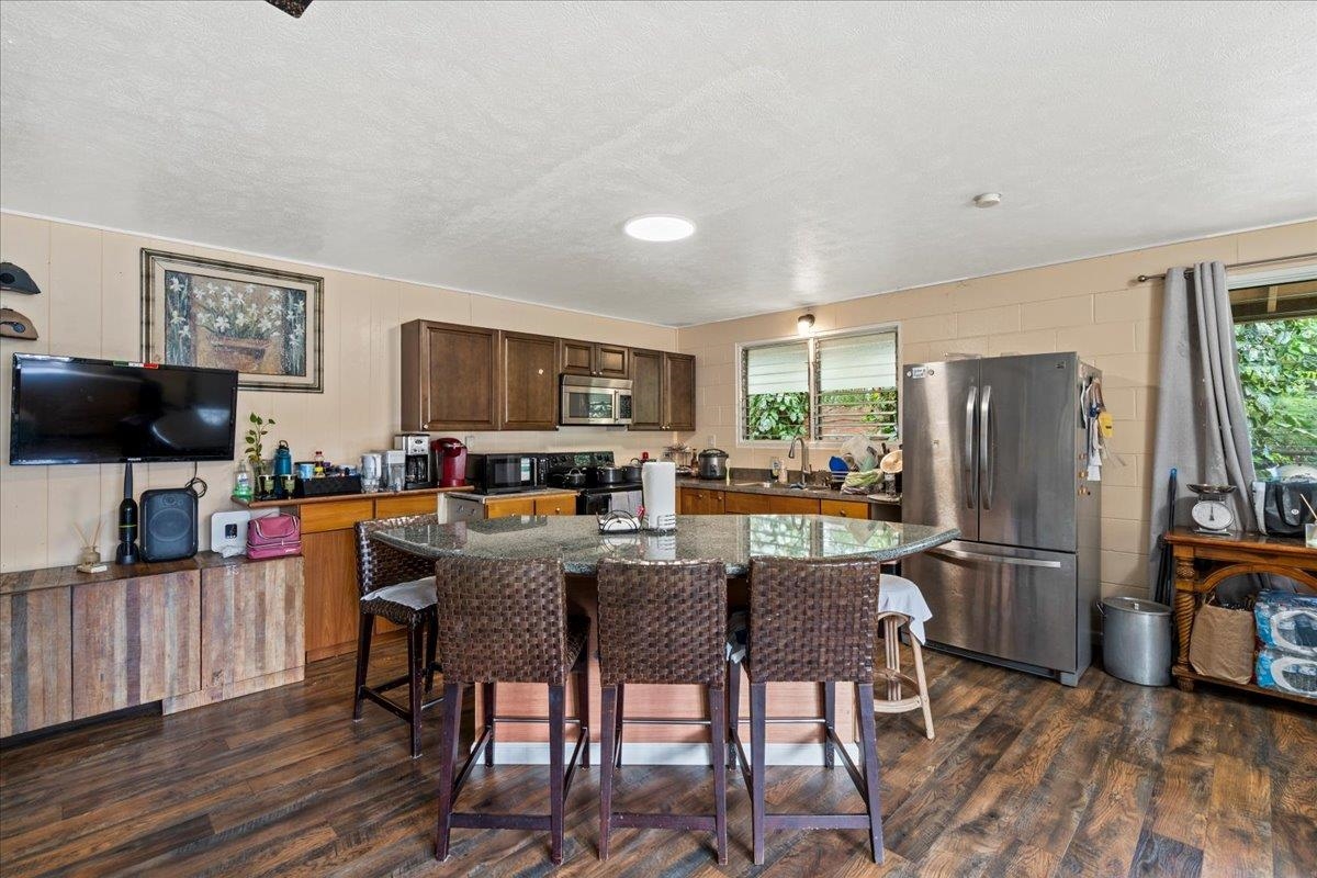 110 Aoloa Loop Kahului, HI 96732 - Photo 10 of 46 a view of a dining room with furniture a rug and wooden floor