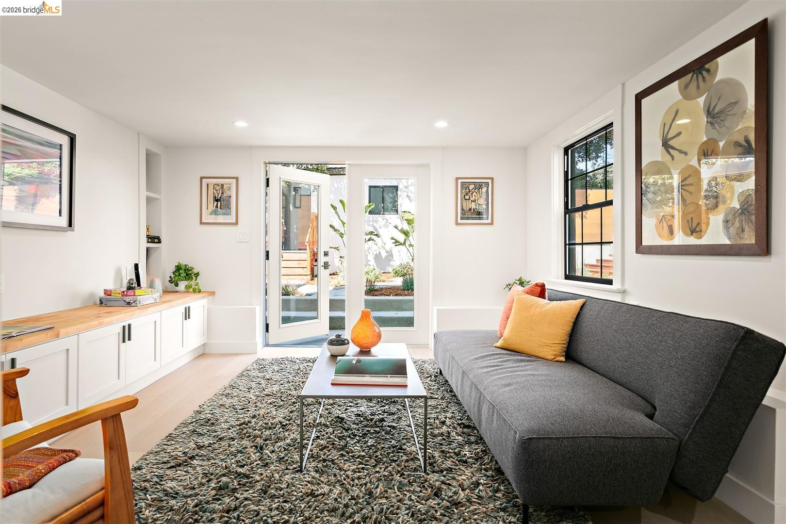 1668 Arch Street Berkeley, CA 94709 - Photo 39 of 78 White walls, recessed lighting, wood-finish flooring, built-in cabinetry with a wood-finish countertop, and French doors