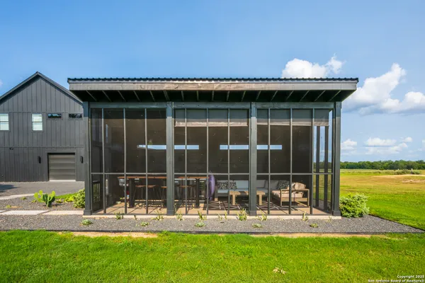 a view of a house with backyard porch and sitting area