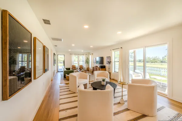 a living room with furniture and large windows