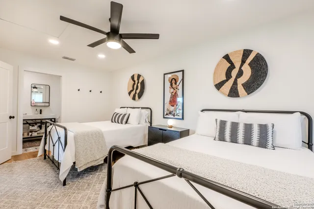 a bedroom with a bed and painting on the wall