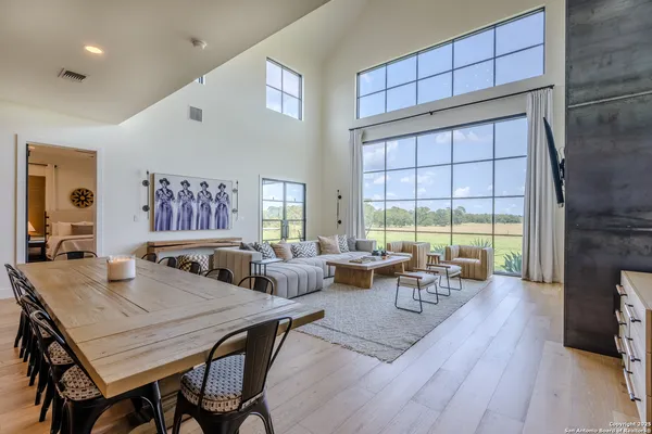 a living room with fireplace furniture and a large window