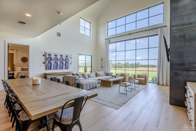 a living room with fireplace furniture and a large window