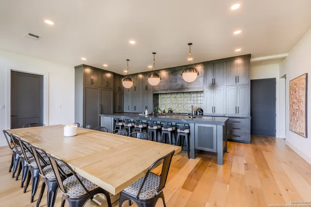 a large kitchen with a table and chairs