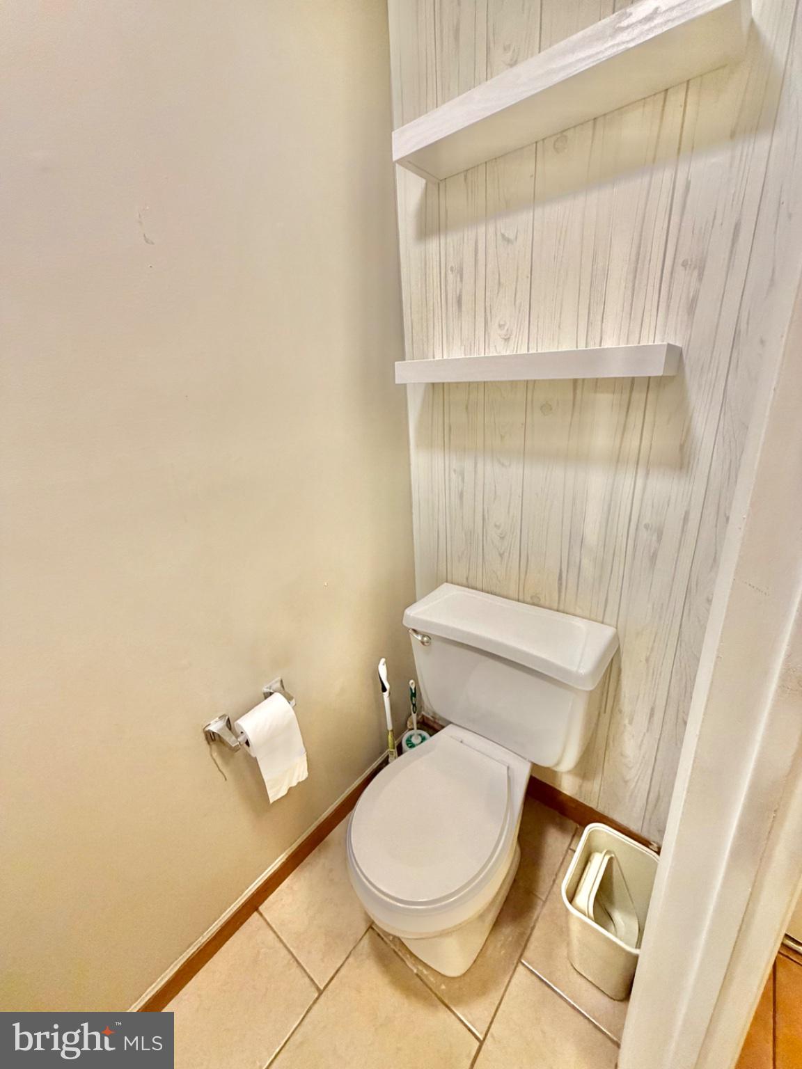 418 Green Street Lancaster, PA 17602 - Photo 14 of 26 a white toilet sitting next to a shower curtain