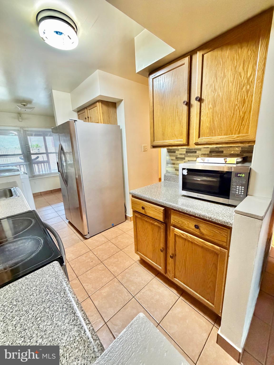 418 Green Street Lancaster, PA 17602 - Photo 6 of 26 a kitchen with stainless steel appliances granite countertop a stove a sink and a refrigerator