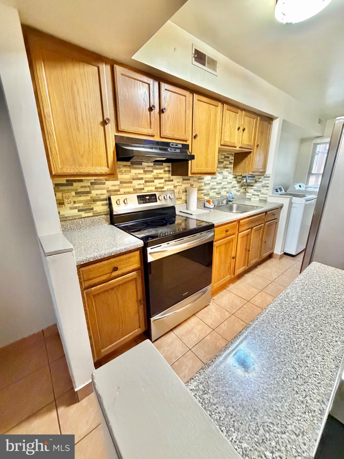 418 Green Street Lancaster, PA 17602 - Photo 7 of 26 a kitchen with stainless steel appliances granite countertop a stove a sink and a microwave