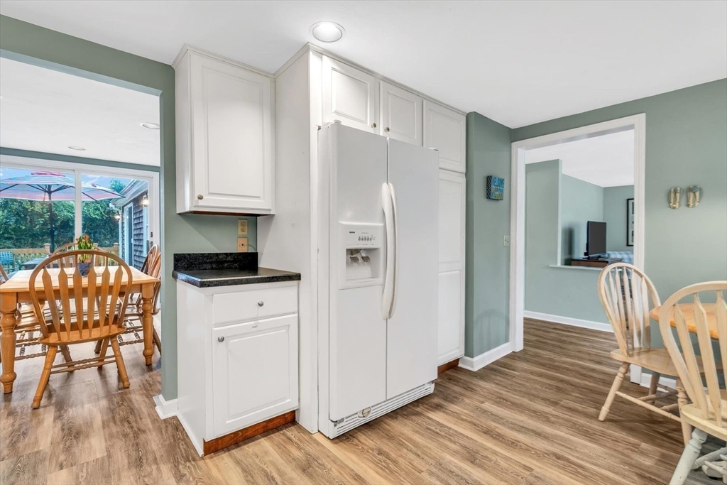 30 Cove Road Eastham, MA 02642 - Photo 19 of 42 a kitchen with a refrigerator and a table chair