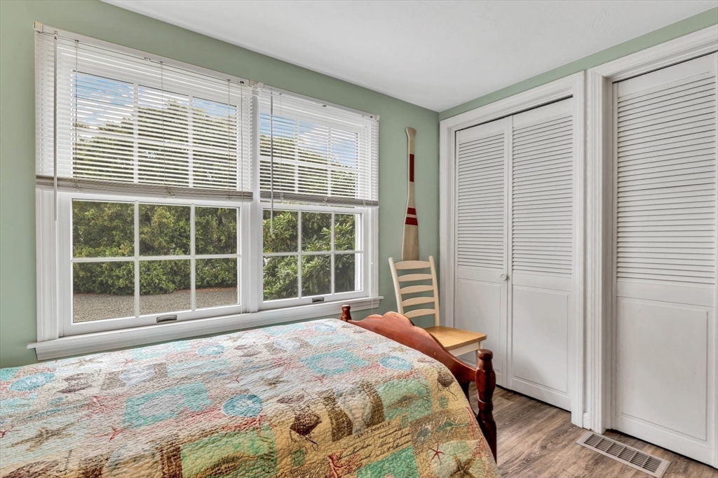 30 Cove Road Eastham, MA 02642 - Photo 24 of 42 a bedroom with a bed and a large window