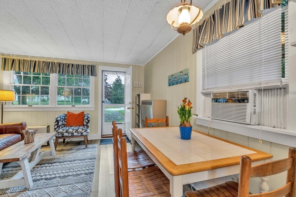 30 Cove Road Eastham, MA 02642 - Photo 32 of 42 a living room with furniture and a potted plant