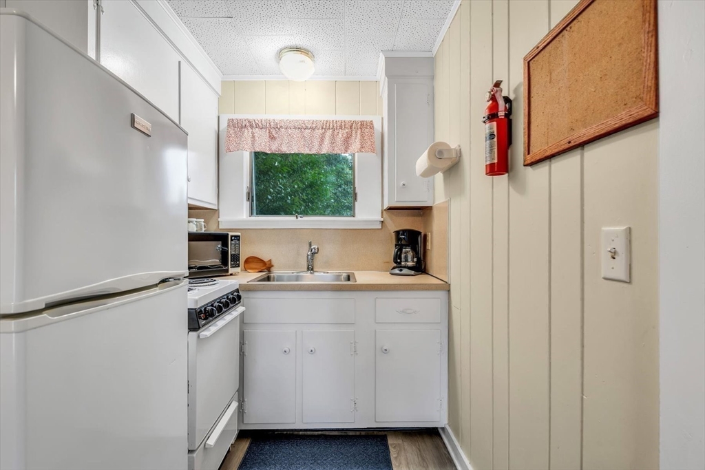 30 Cove Road Eastham, MA 02642 - Photo 34 of 42 a kitchen with a sink cabinets and appliances