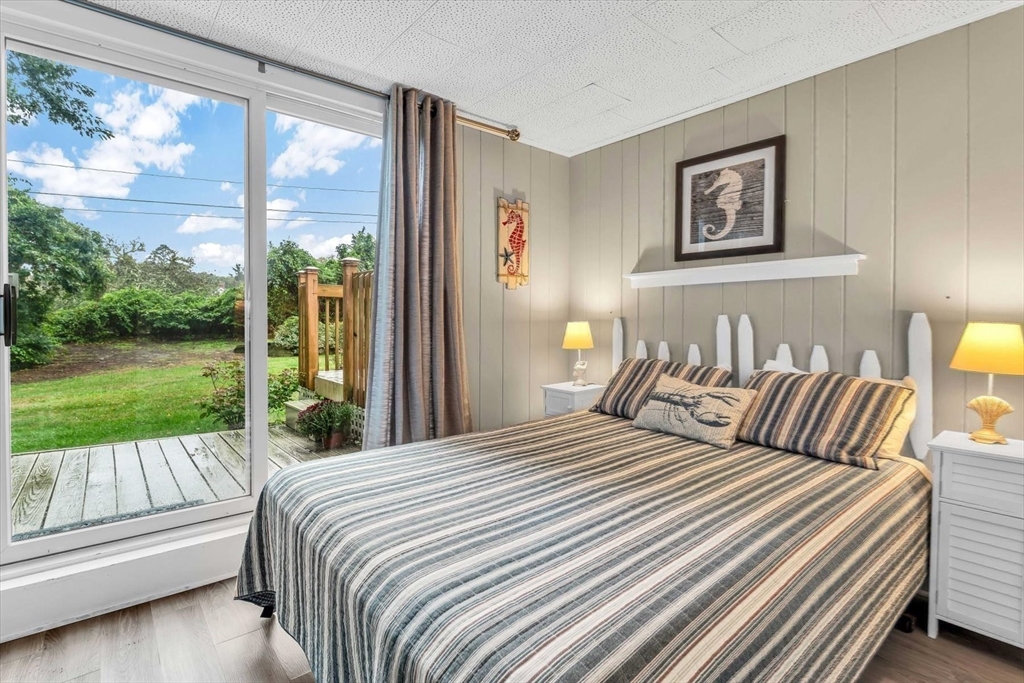 30 Cove Road Eastham, MA 02642 - Photo 37 of 42 a bedroom with a bed and a view of balcony