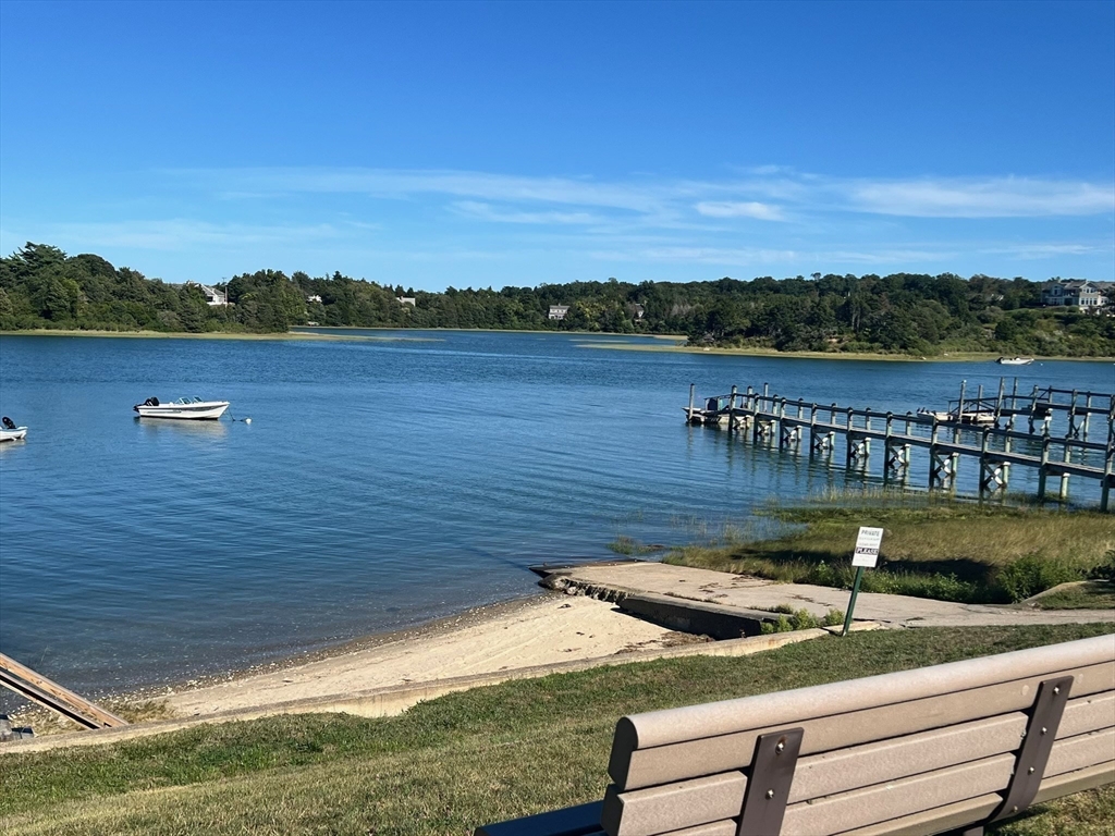 30 Cove Road Eastham, MA 02642 - Photo 4 of 42 a view of a lake with houses in the back