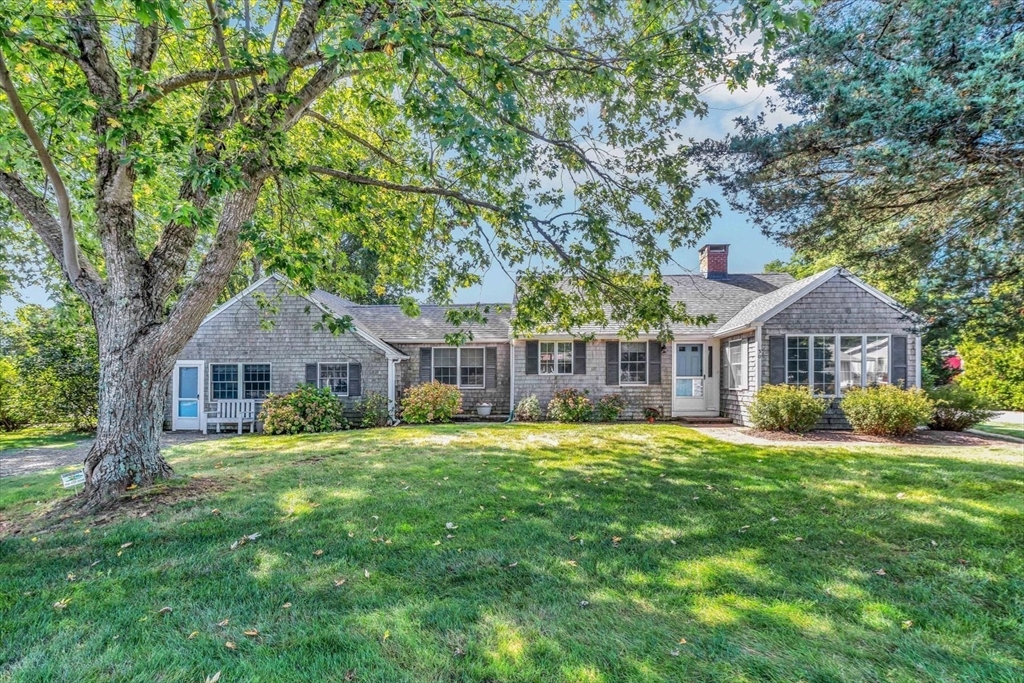 30 Cove Road Eastham, MA 02642 - Photo 6 of 42 a front view of a house with a garden