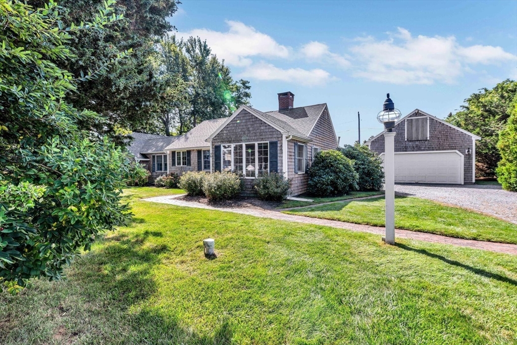 30 Cove Road Eastham, MA 02642 - Photo 7 of 42 a front view of a house with garden