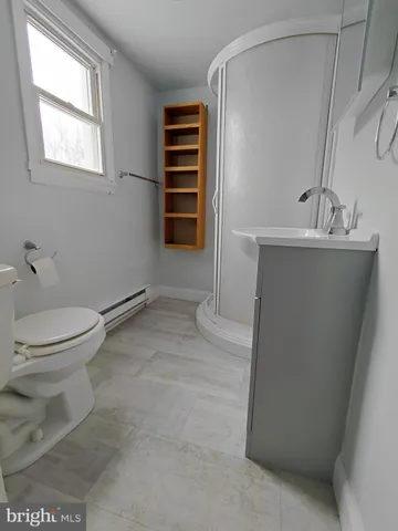 a bathroom with a sink a toilet and a window